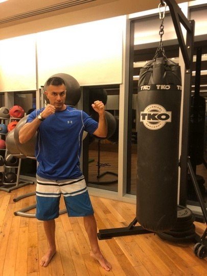 Mah Ghasemi in a training stance beside a heavy bag